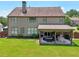 Spacious backyard featuring a covered patio area with outdoor seating and dining at 852 Van Briggle Path, Sugar Hill, GA 30518