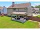 Spacious backyard with a covered patio area perfect for outdoor entertaining at 852 Van Briggle Path, Sugar Hill, GA 30518