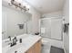 Bright bathroom featuring a shower-tub combo with glass doors and neutral-toned walls at 852 Van Briggle Path, Sugar Hill, GA 30518