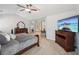 Bright bedroom with ensuite bathroom, dark wood furniture, and a ceiling fan for ultimate comfort at 852 Van Briggle Path, Sugar Hill, GA 30518