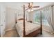 Charming bedroom with a four-poster bed and a ceiling fan for added comfort at 852 Van Briggle Path, Sugar Hill, GA 30518
