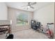 This bedroom includes carpet, a ceiling fan and natural light from a large window at 852 Van Briggle Path, Sugar Hill, GA 30518