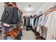 Walk-in closet with rods and shelves for organized storage of clothing, shoes and accessories at 852 Van Briggle Path, Sugar Hill, GA 30518