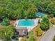 Overhead shot of neighborhood pool and tennis courts surrounded by leafy trees at 852 Van Briggle Path, Sugar Hill, GA 30518