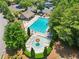 Aerial view of a stunning community pool area with ample seating and mature trees at 852 Van Briggle Path, Sugar Hill, GA 30518