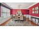 Elegant dining room features hardwood floors, wainscoting, decorative rug, and a modern chandelier at 852 Van Briggle Path, Sugar Hill, GA 30518