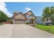 Attractive brick home with a well-manicured lawn and two-car garage, set against a blue sky at 852 Van Briggle Path, Sugar Hill, GA 30518
