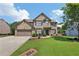 Charming two-story brick home with a well-manicured lawn and attached two car garage at 852 Van Briggle Path, Sugar Hill, GA 30518