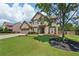 Charming two-story brick home with a well-manicured lawn and attached two car garage at 852 Van Briggle Path, Sugar Hill, GA 30518