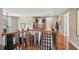 Upstairs hallway with hardwood floors, wood railings, and views of the living area below at 852 Van Briggle Path, Sugar Hill, GA 30518
