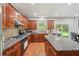 Updated kitchen featuring granite countertops, hardwood floors and an eat-in area that connects to the backyard at 852 Van Briggle Path, Sugar Hill, GA 30518