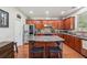 Well-equipped kitchen boasts stainless steel appliances, granite countertops, and a center island at 852 Van Briggle Path, Sugar Hill, GA 30518