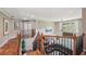 Open living room with hardwood floors, a leather sectional sofa, and large windows at 852 Van Briggle Path, Sugar Hill, GA 30518