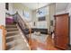 Open concept living room with hardwood floors, large windows, and a staircase at 852 Van Briggle Path, Sugar Hill, GA 30518