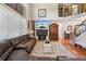 Comfortable living room boasts a cozy fireplace, stylish decor, and an elegant staircase at 852 Van Briggle Path, Sugar Hill, GA 30518