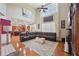Spacious living room with hardwood floors, large windows, and a comfortable sectional sofa at 852 Van Briggle Path, Sugar Hill, GA 30518