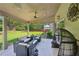 A view of the covered patio with outdoor seating and dining area, overlooking the well-maintained backyard and landscaping at 852 Van Briggle Path, Sugar Hill, GA 30518