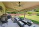 Covered patio featuring ceiling fans, an outdoor dining area, and comfortable seating overlooking the backyard at 852 Van Briggle Path, Sugar Hill, GA 30518