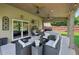 Cozy covered patio with outdoor seating and a ceiling fan, great for relaxation or entertaining at 852 Van Briggle Path, Sugar Hill, GA 30518