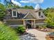 Charming pool house entrance with stone accents and lush landscaping at 852 Van Briggle Path, Sugar Hill, GA 30518