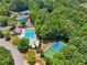 A lush residential community pool and a tennis and pickleball complex nestled among dense, green trees at 852 Van Briggle Path, Sugar Hill, GA 30518
