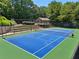 A well-kept, professional-grade tennis court with lighting and seating for spectators at 852 Van Briggle Path, Sugar Hill, GA 30518
