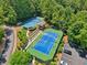 View of tennis courts with professional-grade surfaces, lighting and seating at 852 Van Briggle Path, Sugar Hill, GA 30518