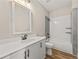 Chic bathroom features white tiling, modern fixtures, and wood-look floors at 925 Willingham Dr # 13, Hapeville, GA 30354