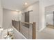 Upstairs hallway with wood railing, gray sliding door, and view into the living room at 925 Willingham Dr # 13, Hapeville, GA 30354