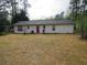 Large backyard with a red door and mature trees offering privacy at 218 Whispering Pine Circle Ne Cir, White, GA 30184
