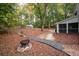 Beautiful backyard featuring fire pit, lush landscaping and mature trees at 2377 Emory Ln, Marietta, GA 30068