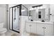 Modern bathroom featuring a glass-enclosed shower and double vanity with marble countertop at 2377 Emory Ln, Marietta, GA 30068