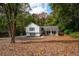 Split-level home with brick and vinyl siding, nestled in a lush wooded lot with mature trees and an ample front yard at 2377 Emory Ln, Marietta, GA 30068
