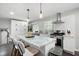 Open kitchen with a marble island, stainless steel appliances, and white subway tile backsplash at 2377 Emory Ln, Marietta, GA 30068