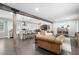 Open-concept living space flowing to the kitchen, featuring dark floors, exposed wood beams, and modern furnishings at 2377 Emory Ln, Marietta, GA 30068