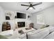 Bright living room features a fireplace, gray couch, and a large window at 2377 Emory Ln, Marietta, GA 30068