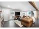 Bright living room with hardwood floors, a leather sofa, and a decorative beam at 2377 Emory Ln, Marietta, GA 30068