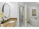 Bathroom with granite countertops, dual sinks, and a view into an organizing closet at 2828 Peachtree Nw Rd # 1502, Atlanta, GA 30305