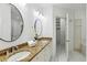 A bathroom with dual sinks, granite countertops, and a large mirror, leading to a walk-in closet at 2828 Peachtree Nw Rd # 1502, Atlanta, GA 30305