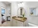 Bathroom with a granite vanity, decorative mirror, and travertine flooring, and nearby access to the living area at 2828 Peachtree Nw Rd # 1502, Atlanta, GA 30305