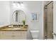 Bright bathroom featuring a granite countertop, round mirror, and a glass-enclosed shower at 2828 Peachtree Nw Rd # 1502, Atlanta, GA 30305