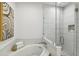 Elegant bathroom featuring a soaking tub and a walk-in shower with neutral colored tile work at 2828 Peachtree Nw Rd # 1502, Atlanta, GA 30305