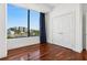 Bright bedroom with hardwood floors and a large window offering city views and ample natural light at 2828 Peachtree Nw Rd # 1502, Atlanta, GA 30305