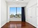 Bright bedroom with hardwood floors, large windows offering city views, and ample natural light at 2828 Peachtree Nw Rd # 1502, Atlanta, GA 30305