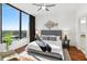 Primary bedroom featuring a large window with expansive views, accent chair and hardwood floors at 2828 Peachtree Nw Rd # 1502, Atlanta, GA 30305
