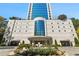 Stately condo entrance featuring modern architecture, a landscaped circular driveway and covered parking access at 2828 Peachtree Nw Rd # 1502, Atlanta, GA 30305