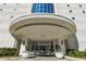 Well lit condo building entrance featuring manicured landscaping and an elegant covered entryway at 2828 Peachtree Nw Rd # 1502, Atlanta, GA 30305