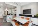 Inviting dining area with a modern table, stylish chairs, and a large TV at 2828 Peachtree Nw Rd # 1502, Atlanta, GA 30305