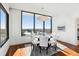 Dining room boasts hardwood floors, modern lighting, and city views at 2828 Peachtree Nw Rd # 1502, Atlanta, GA 30305