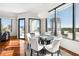 Dining room boasts hardwood floors, modern lighting, and city views at 2828 Peachtree Nw Rd # 1502, Atlanta, GA 30305